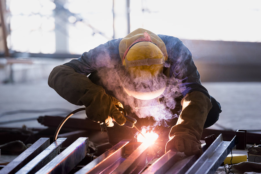 man welding a metal