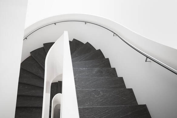 Curved staircase with curved handrail wall mounted